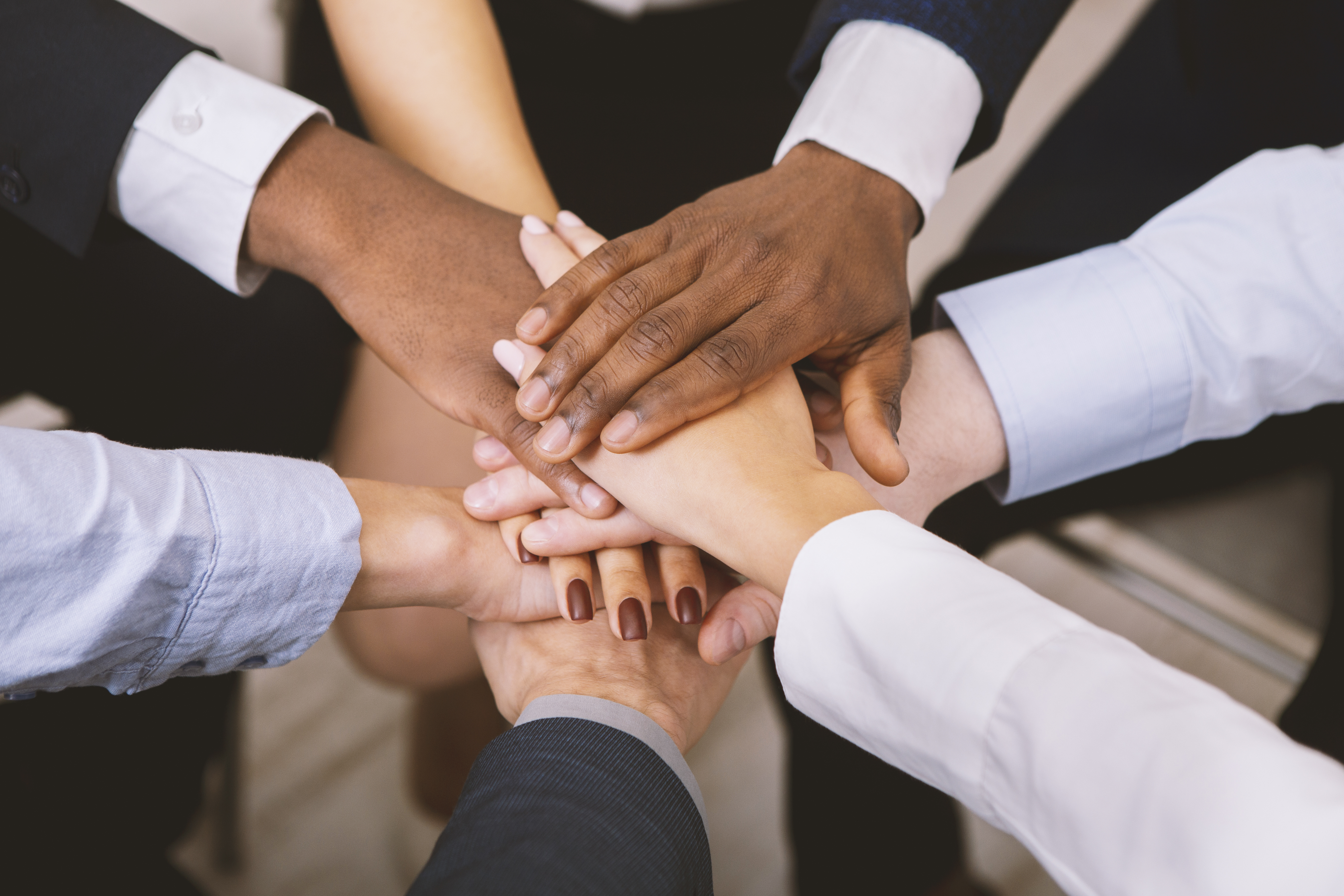 Team meeting hands in the middle